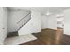 Inviting living room featuring hardwood floors, a staircase, and doorway leading into the kitchen at 3343 Ashley Ln, Indianapolis, IN 46224
