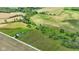 Scenic aerial perspective highlights the home, set among lush fields and trees at 3450 Clay Rd, North Salem, IN 46165