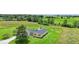Picturesque aerial view of home with large yard, American flag and playset surrounded by beautiful greenery at 3450 Clay Rd, North Salem, IN 46165