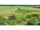 High aerial view showing the house with the shed, playset and ample property surrounded by farmland at 3450 Clay Rd, North Salem, IN 46165