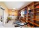 Finished basement area with wood built-in shelves and exercise equipment at 3450 Clay Rd, North Salem, IN 46165