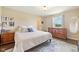 Bright bedroom featuring a plush queen bed, wood floors, and a vintage dresser at 3450 Clay Rd, North Salem, IN 46165