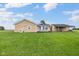 Backyard view showcasing a sunroom, covered patio, and generous lawn space at 3450 Clay Rd, North Salem, IN 46165