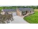 Charming home with tan siding, black shutters, and a gravel driveway leading to an attached garage at 3450 Clay Rd, North Salem, IN 46165