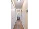 Long hallway with wood floors, closet space, and neutral paint at 3450 Clay Rd, North Salem, IN 46165