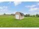 Exterior view of a well-maintained storage shed in a lush green yard at 3450 Clay Rd, North Salem, IN 46165