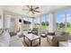 Inviting sunroom with large windows, ceiling fan, and comfortable seating offers serene views at 3450 Clay Rd, North Salem, IN 46165