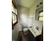 Bathroom features a window above the toilet for natural light and a dark vanity at 3525 Lombardy Pl, Indianapolis, IN 46226