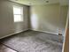 Clean bedroom with gray walls, new carpet and a bright window at 3525 Lombardy Pl, Indianapolis, IN 46226