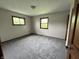 This bedroom features neutral walls and carpet, with two windows providing lots of natural light at 3525 Lombardy Pl, Indianapolis, IN 46226
