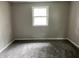 This bedroom features neutral walls and carpet, with a large window providing lots of natural light at 3525 Lombardy Pl, Indianapolis, IN 46226