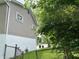View of the home's side siding and landscaping at 3525 Lombardy Pl, Indianapolis, IN 46226