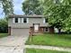 Charming two-story home featuring a welcoming front porch and attached two-car garage at 3525 Lombardy Pl, Indianapolis, IN 46226