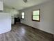 Kitchen features stainless steel oven, white cabinetry, and new luxury vinyl plank flooring at 3525 Lombardy Pl, Indianapolis, IN 46226
