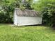 Back view of the shed sitting in the grass at 3525 Lombardy Pl, Indianapolis, IN 46226