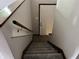 This carpeted stairway leads to the upper level, with a wooden handrail for added safety at 3525 Lombardy Pl, Indianapolis, IN 46226