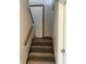 This carpeted stairway leads to the upper level, with a wooden handrail for added safety at 3525 Lombardy Pl, Indianapolis, IN 46226