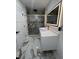 Elegant bathroom featuring a glass door shower, marble flooring, gold hardware, and a lighted mirror at 3962 Graceland Ave, Indianapolis, IN 46208