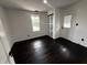 Bright bedroom featuring hardwood floors, a window, closet and a door to the outside at 3962 Graceland Ave, Indianapolis, IN 46208