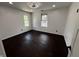 Bright bedroom with hardwood floors, large windows, and modern ceiling fan at 3962 Graceland Ave, Indianapolis, IN 46208