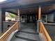 Inviting front porch with steps leading up to a covered entrance, stylish railings, and modern lighting at 3962 Graceland Ave, Indianapolis, IN 46208
