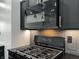 Close up of stainless steel appliances including a microwave, stove and grey subway tile backsplash at 3962 Graceland Ave, Indianapolis, IN 46208