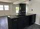 Kitchen with black stone countertops, new cabinets, stainless steel appliances and electric fireplace at 3962 Graceland Ave, Indianapolis, IN 46208