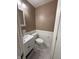 Half bathroom featuring a toilet, sink with white vanity, and a paneled wall at 4404 London Ct, Indianapolis, IN 46254