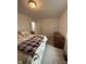 This bedroom has 1 window, dresser, and an unmade bed with an ugly comforter at 4404 London Ct, Indianapolis, IN 46254