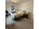 This bedroom has 2 windows, dresser, and an unmade bed with an ugly comforter at 4404 London Ct, Indianapolis, IN 46254