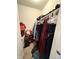 This is a walk in closet with a lot of items. A red Santa bag is visible at 4404 London Ct, Indianapolis, IN 46254