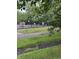 View of the community pool behind a black fence, with a sidewalk leading to the entrance at 4404 London Ct, Indianapolis, IN 46254