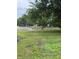 Outdoor community pool enclosed by a black fence, surrounded by lush green grass and mature trees at 4404 London Ct, Indianapolis, IN 46254