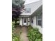 Charming home entrance featuring a white door with sidelights and tidy landscaping at 4404 London Ct, Indianapolis, IN 46254