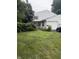 Exterior shot showing the house, lawn, mature trees, and a two-car garage at 4404 London Ct, Indianapolis, IN 46254