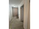 Upstairs hallway featuring neutral carpeting and two entryways to other rooms at 4404 London Ct, Indianapolis, IN 46254