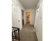 Upstairs hallway with neutral carpeting and three doors to other rooms at 4404 London Ct, Indianapolis, IN 46254