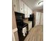 Functional kitchen with white cabinets, laminate countertops, and black appliances at 4404 London Ct, Indianapolis, IN 46254