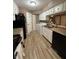 Bright kitchen featuring a sink, laminate countertops, washing machine and white cabinets at 4404 London Ct, Indianapolis, IN 46254