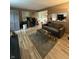 View of the living room with wood laminate flooring and a view to the kitchen at 4404 London Ct, Indianapolis, IN 46254