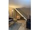 Cozy living room featuring a gray sofa, coffee table, and staircase at 4404 London Ct, Indianapolis, IN 46254