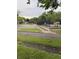 Parking lot adjacent to the community pool, surrounded by green spaces and mature trees at 4404 London Ct, Indianapolis, IN 46254