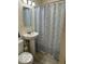 Bathroom featuring a pedestal sink, mirror, and shower with a decorative curtain at 4405 Primrose Ave, Indianapolis, IN 46205