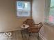 Cozy sitting area featuring wicker chairs, a table, and natural light from the windows at 4405 Primrose Ave, Indianapolis, IN 46205