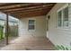 View of the wooden back porch with an entrance to the house, offering an outdoor living space at 4517 E 16Th St, Indianapolis, IN 46201
