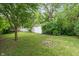 Lush backyard with a fire pit and view of the home, offering outdoor relaxation and entertainment at 4517 E 16Th St, Indianapolis, IN 46201