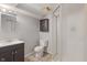 Basement bathroom with a tiled floor, vanity sink, toilet, medicine cabinet, and a walk-in shower at 4517 E 16Th St, Indianapolis, IN 46201