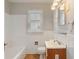 Bathroom featuring white tiles and a wood-finish vanity for a clean and classic look at 4517 E 16Th St, Indianapolis, IN 46201