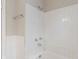 Bathroom with white tiles and a shower head, creating a functional and clean space at 4517 E 16Th St, Indianapolis, IN 46201