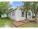 Quaint single-story home featuring classic siding, a bay window, and a cozy front porch at 4517 E 16Th St, Indianapolis, IN 46201